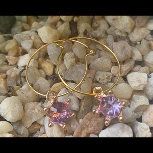 Gold hoops with pink crystal star charms.